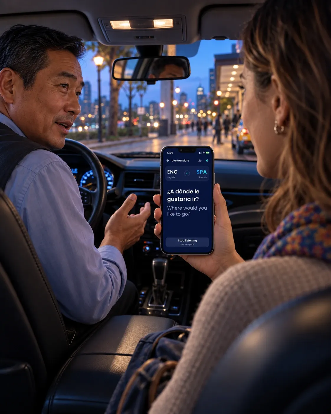 A passenger holds a phone out to a taxi driver; the screen shows his Spanish above its English translation